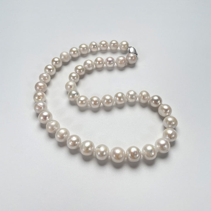 Natural freshwater pearl necklace featuring 10mm round pearls and a silver yuanbao clasp, styled in a full circle on a white background.