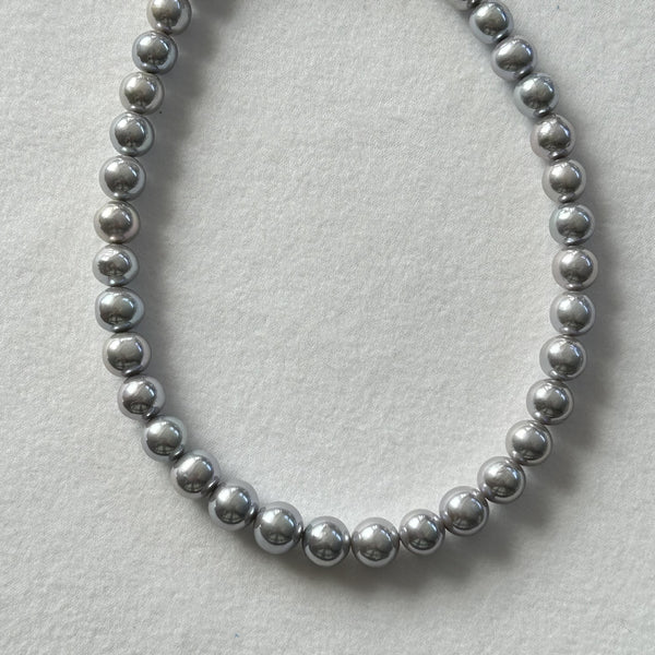 Natural freshwater pearl necklace in smoky grey tone on white background