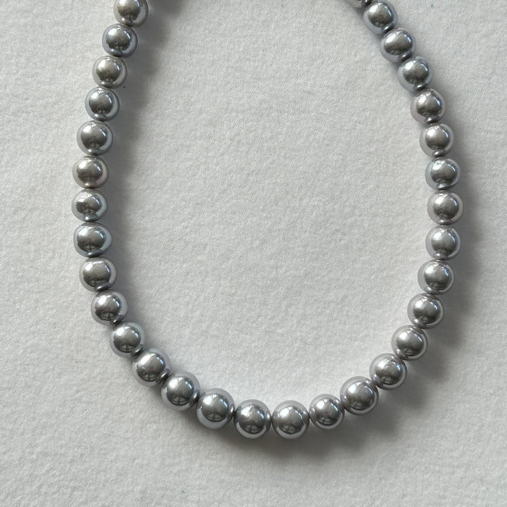 Natural freshwater pearl necklace in smoky grey tone on white background