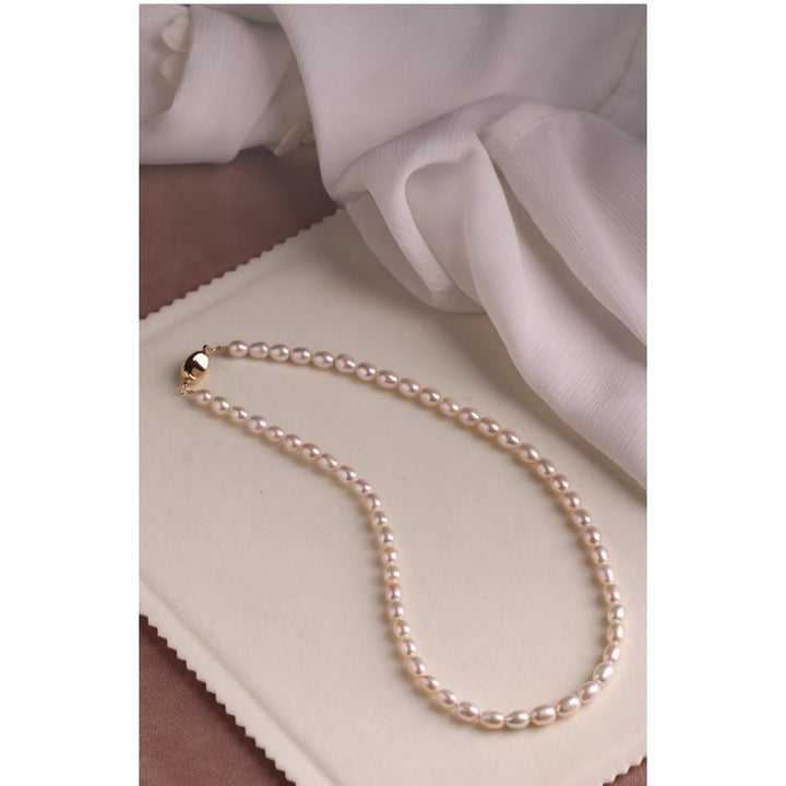 Natural freshwater pearl necklace featuring 10mm round pearls and a silver yuanbao clasp, styled in a full circle on a white background.