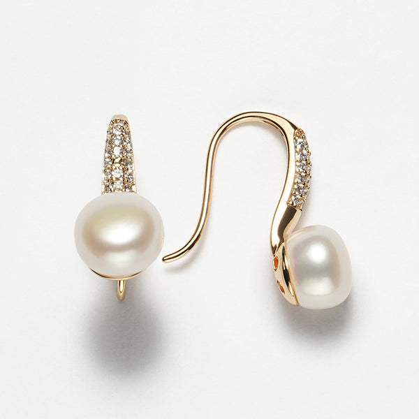 Close-up image of 8mm round white freshwater pearl earrings with a gold-tone stiletto heel-inspired hook design and pavé-set crystals.