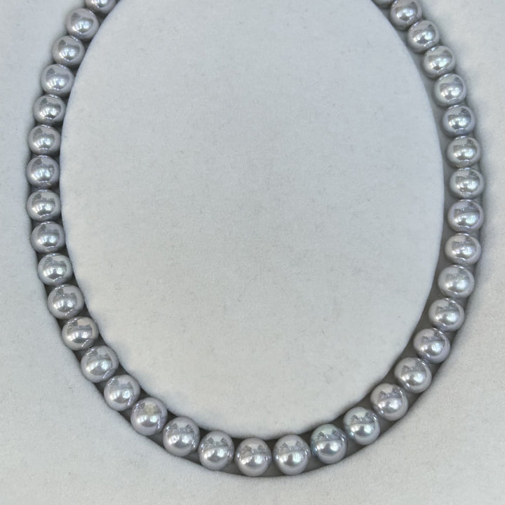 Natural freshwater pearl necklace in smoky grey tone on white background