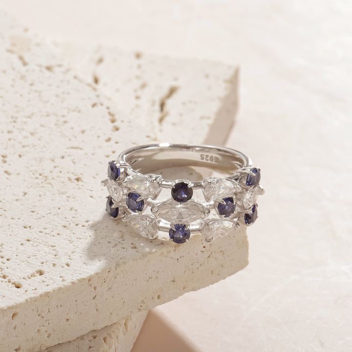 Close-up of lab sapphire and moissanite ring in sterling silver