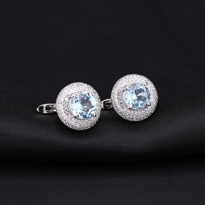 Close-up of 2.57 carat sky blue topaz gemstone earrings with white CZ halo