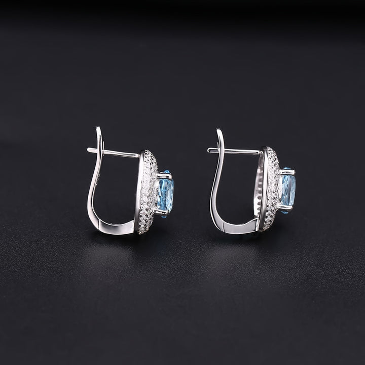 Close-up of 2.57 carat sky blue topaz gemstone earrings with white CZ halo