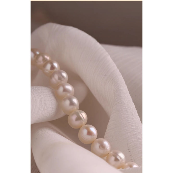 Natural freshwater pearl necklace featuring 10mm round pearls and a silver yuanbao clasp, styled in a full circle on a white background.
