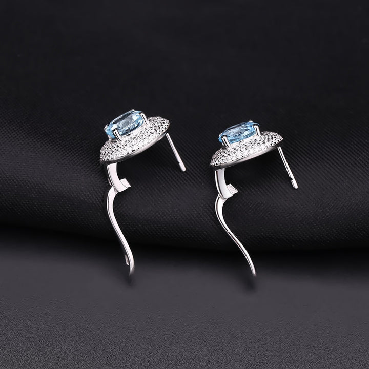 Close-up of 2.57 carat sky blue topaz gemstone earrings with white CZ halo